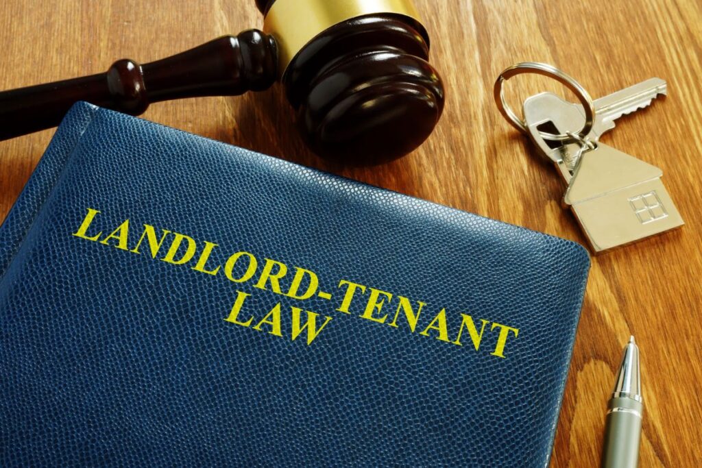 Landlord-Tenant Law book with key and home model, 2025 updates, Sacramento, California