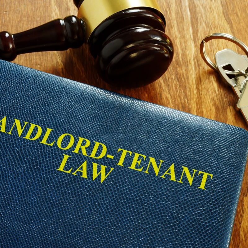 Landlord-Tenant Law book with key and home model, 2025 updates, Sacramento, California